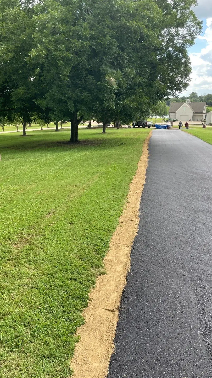 Fresh asphalt driveway edge, finished by the PavePro crew in spring 2026.