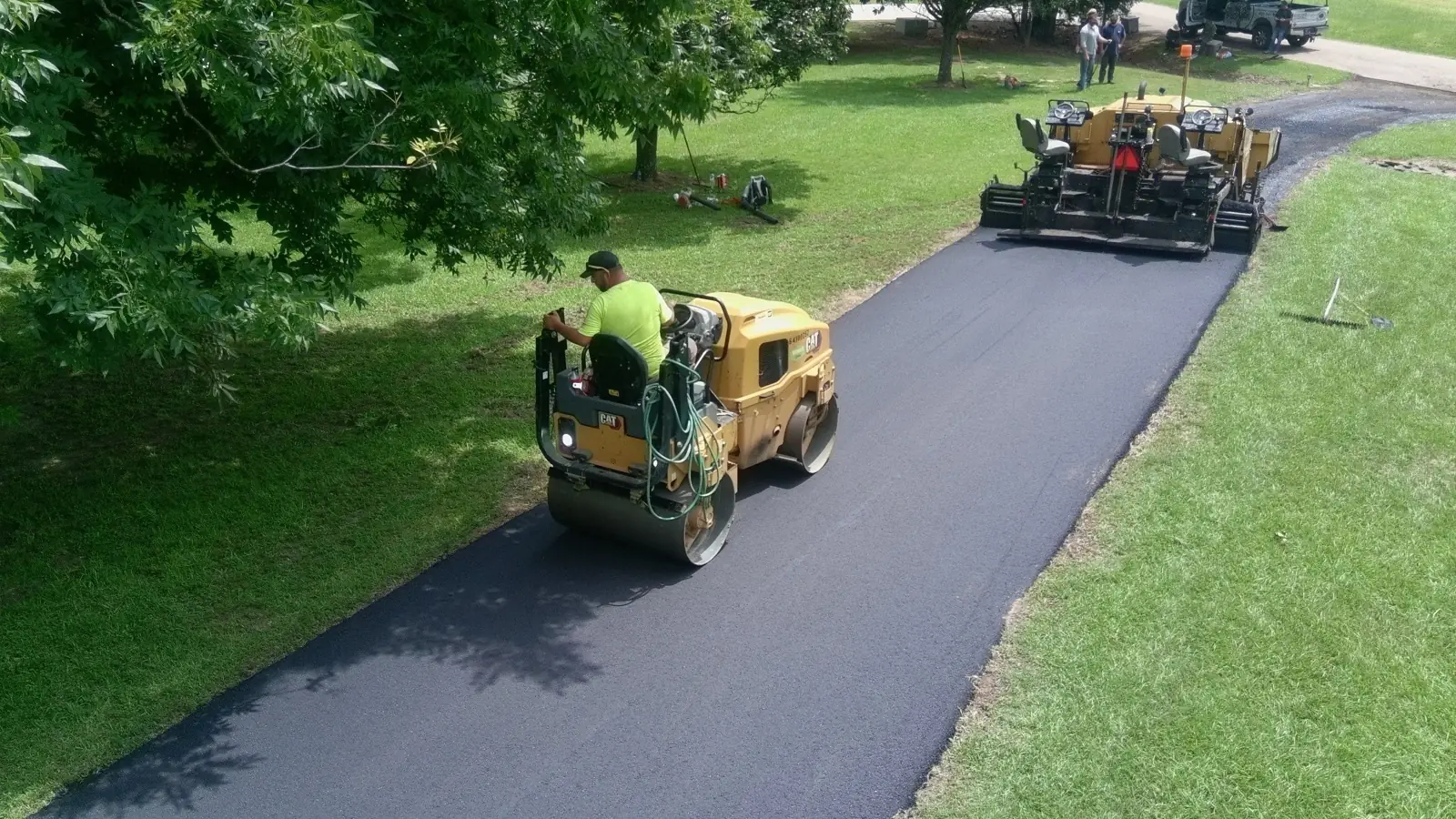 Overhead view of a finished asphalt driveway paving job, representing the conversion phase of the Hot Mix Method.